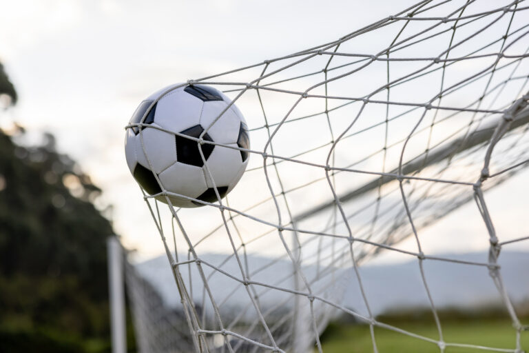 Close-up on a soccer ball hitting the goal net after scoring - scoring a goal concepts/>
  </div>
  <div class=